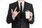 Business lunches coffee theme: businessman in a black suit holding a white blank paper cup of coffee with a brown plastic cap isol