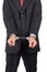 Business man with a black suit in handcuffs