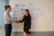 Business man and business woman stand and shaking hands for success business agreement