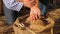 Business man checks the quality of wheat. Close-up. Farmer\'s hands pour wheat grains in a bag with ears. Harvesting