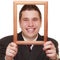 Business man framing his face with wood frame