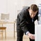 Business man gets water from water cooler