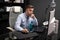 Business man with glasses working in the office at computer table and drinking coffee from bright Cup