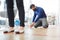 Business man glues distance marker on the floor