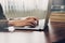 Business man hand texting laptop on wooden table