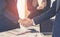 Business man with handshake with partner and woman cheering