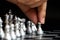 Business man hold pawn to first move in chess game