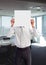 Business man holding blank card in office