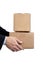 Business man holding cardboard moving box on white