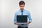 Business man holding a laptop against a white background