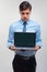 Business man holding a laptop against a white background