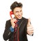 Business man holding thumbs up during phone call