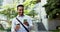 Business man, phone and texting in city with coffee, smile and walk on urban sidewalk with mobile networking. Asian