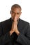 Business man praying using prayer gesture eyes ope