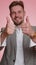 Business man raises thumbs up agrees or gives positive reply recommends advertisement likes good