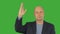 Business man raising right hand up and attracting attention on green screen. Alpha channel, keyed green screen.