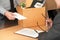 Business man sending resignation letter to boss and Holding Stuff Resign Depress or carrying cardboard box by desk in office.