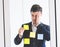 Business man shocking on idea on post it windows for plan