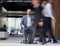 Business man sitting in office chair, people group passing by