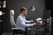 Business man sitting in office at a computer Desk and looking at monitor