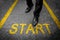 Business man standing on tarmac road background with yellow start text concept. Top view. Businessman with starting challenge of