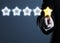 Business man in suit pointing at five star rating stars, selecting top rating