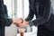 Business man in a suit shakes hands to agree a business partnership agreement. Business etiquette concept of congratulation,