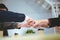 Business man in a suit shakes hands to agree a business partnership agreement. Business etiquette concept of congratulation,