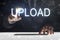 Business man touching screen with `Upload` writing