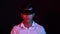Business man try vr glasses hololens in the dark room. Colorful portrait of young Asian boy wearing virtual reality headset.