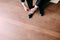 Business man tying shoe laces on the floor. Groom getting ready in the morning before the wedding