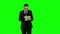 Business man use laptop and makes online shopping. Green screen.