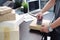 Business man using Metal Tape Dispenser and packing a parcel box on black desk in home office .selective focus.product packaging