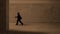 Business man walking in Concrete Grey wall interior textured passage. Man walks in Dark Building with walls. Grungy textured Floor