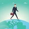 Business man walking over terrestrial globe crossing borders and