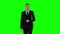 Business man walking and use laptop. Green screen.