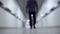 Business man walks down the corridor. Blurred background. Bottom view, perspective. 4Ðš
