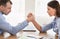 Business Man And Woman Arm Wrestling At Work In Office