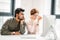 Business man and woman colleagues looking at computer trying to solve problems in office