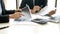 business man and woman sit at ther table looking at computer laptop