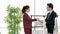 Business man and woman workers discuss with work and then shake hands with two hands