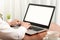 Business man working on laptop computer at home while sitting the wooden table.Male hands typing on the notebook keyboard.Online