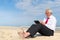 Business man working on tablet at the beach