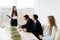 Business meeting. Business woman give notice for team while sitting together at the table