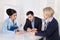 Business meeting. Three people sitting at the table in an office