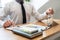 Business men laying coins down In a glass bottle next to the coin chart, expanding a successful and economical business for