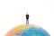 Business miniature people standing on the globe
