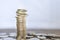 Business, Money, Finance, Security and Saving Concept. Close up of unstable stack of coins on wooden table with copy space