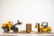 Business, Money and Financial Concept. Closeup  mini forklift and loader truck mini car toy model contain coins to stack of gold