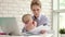 Business mother working from home with kid. Mother with child looking documents